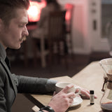 Man drinking coffee with handlebar mustache